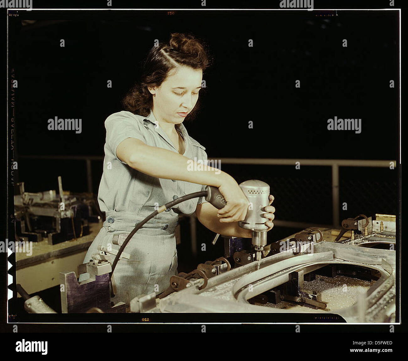 Drilling a wing bulkhead for a transport plane at the Consolidated Aircraft Corporation plant, Fort Worth, Texas (LOC) Stock Photo