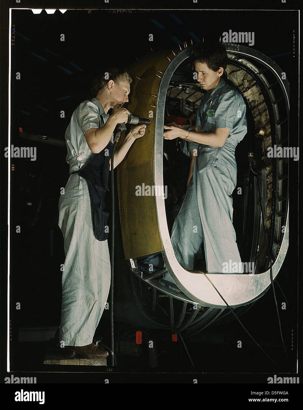 Frances Eggleston, aged 23, came from Oklahoma, used to do office work. Removing paper from pilot's window(?), Consolidated Aircraft Corp., Fort Worth, Texas (LOC) Stock Photo