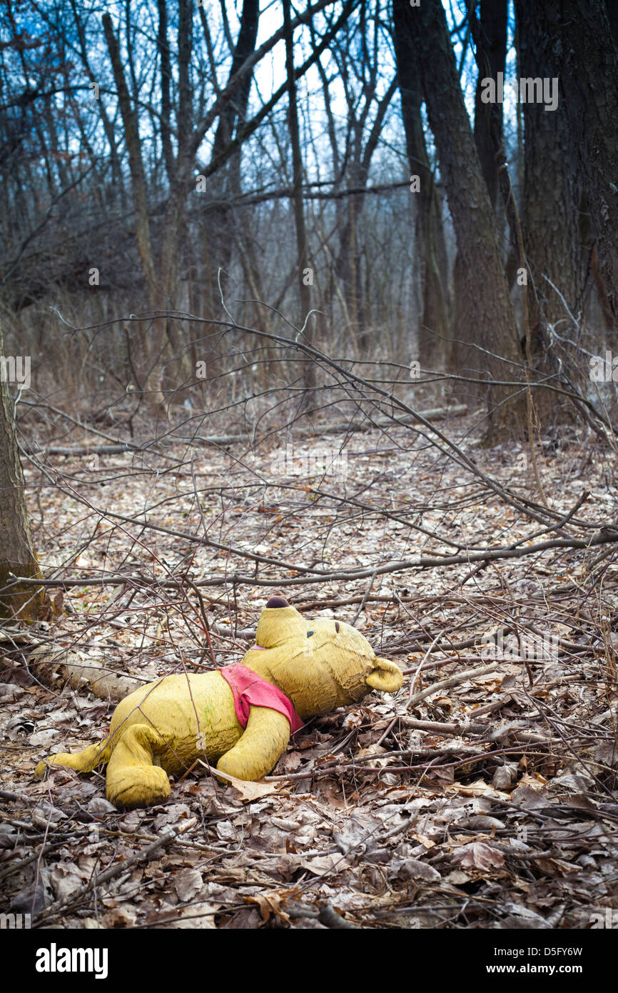 winnie the pooh stuffed animal abandoned in the woods Stock Photo