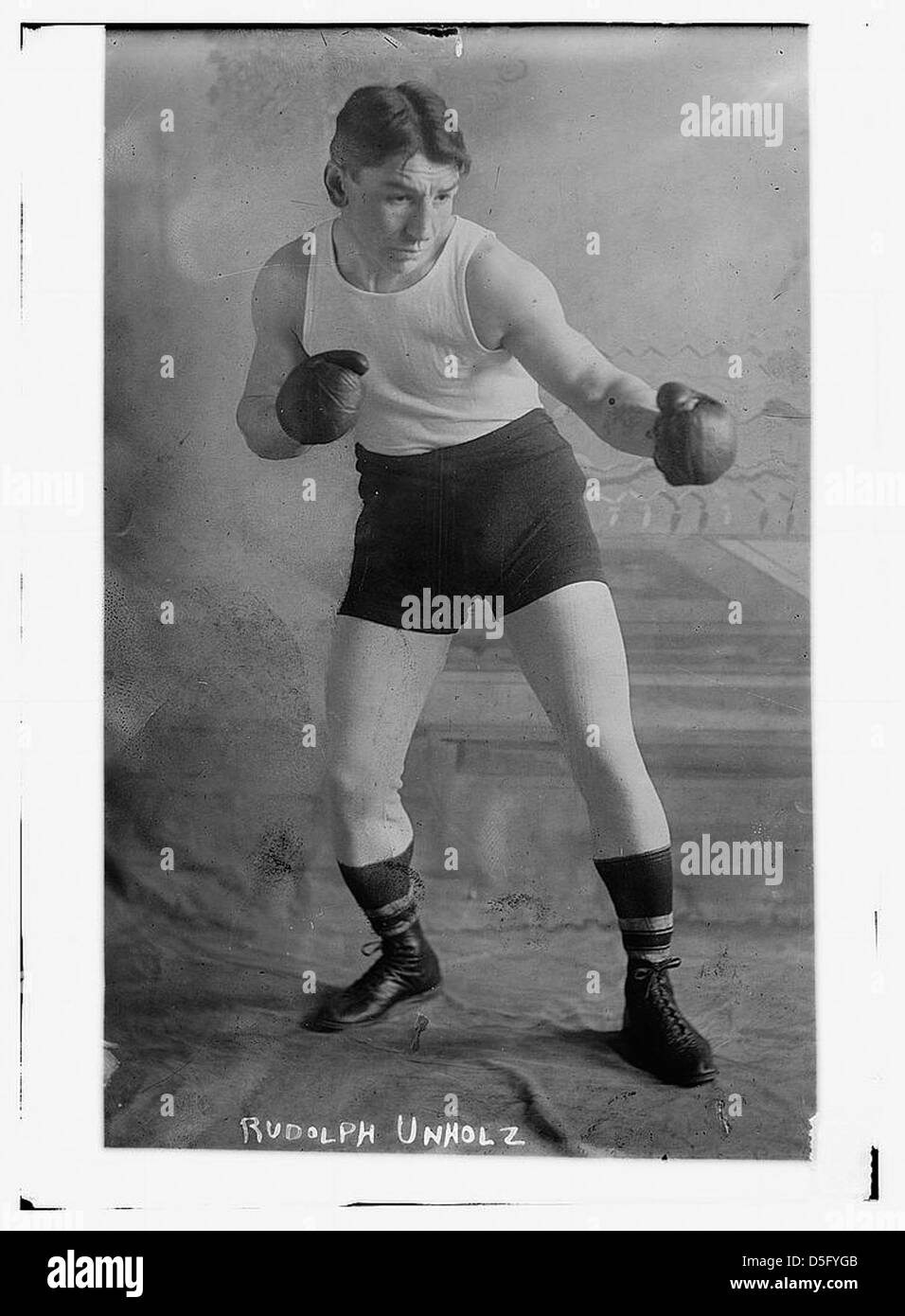 Rudolph Unholz, an early 20th-century boxer, is portrayed in a historical photograph, representing the athletic culture of the time. Stock Photo