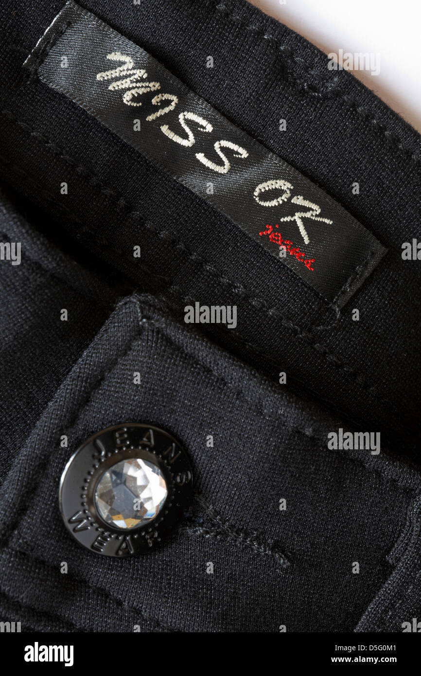 miss ok jeans wear - button on black jeans with label Stock - Alamy