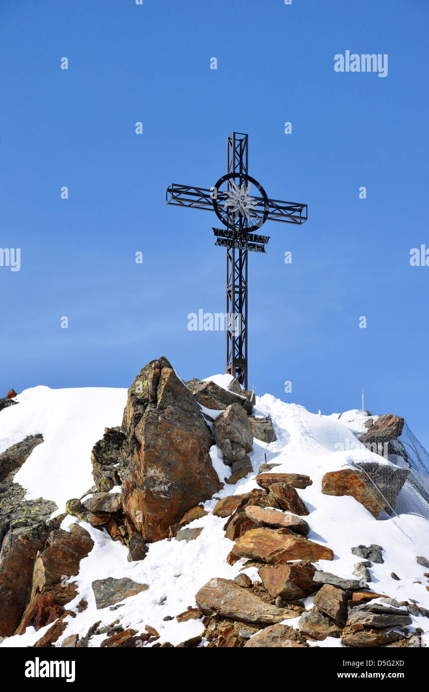 Iron cross on the top of the Gaislachkogl mountain near Solden in the Zillertal Alps in Austria Stock Photo
