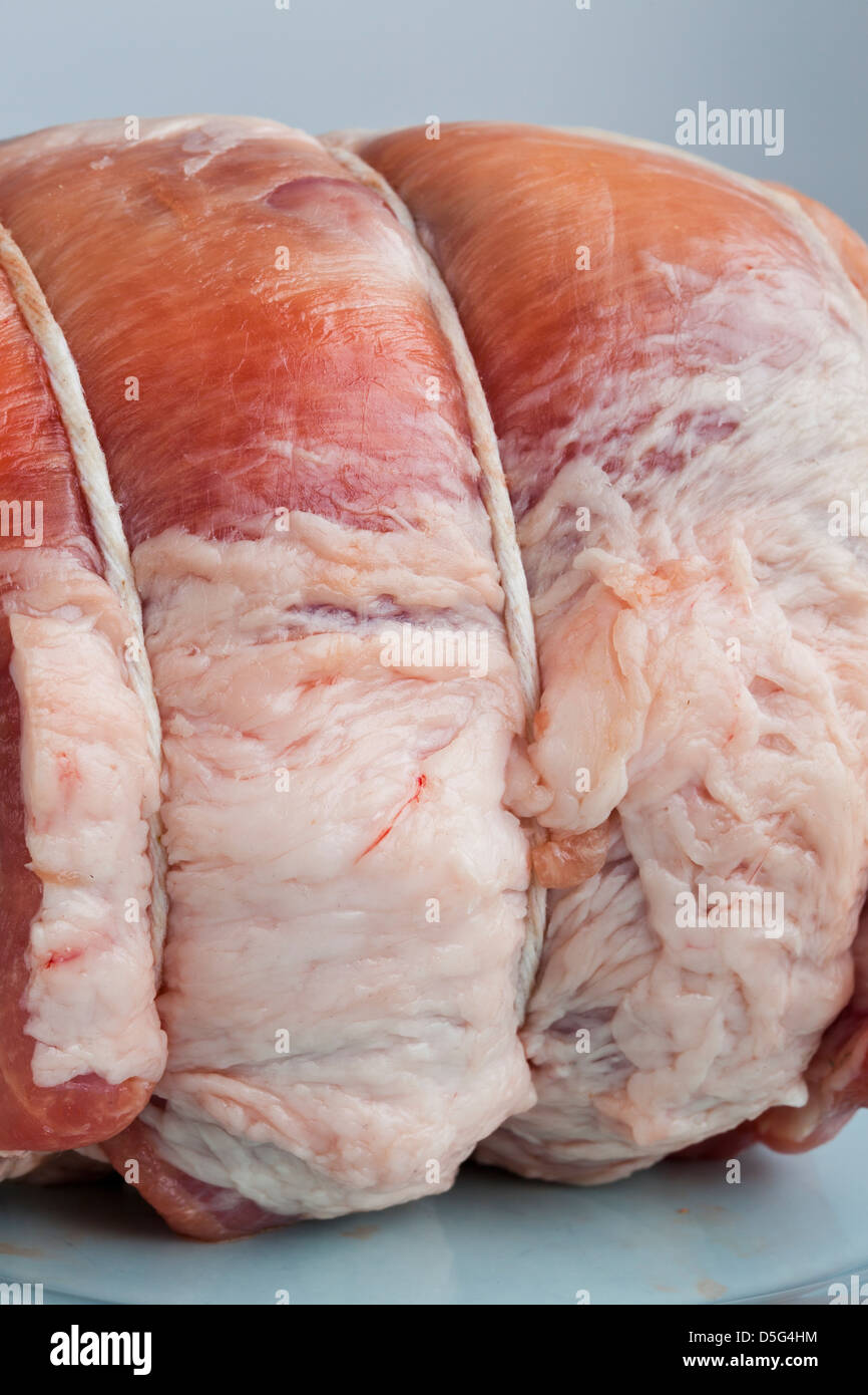 2.5 pound raw pork roast on a blue plate Stock Photo