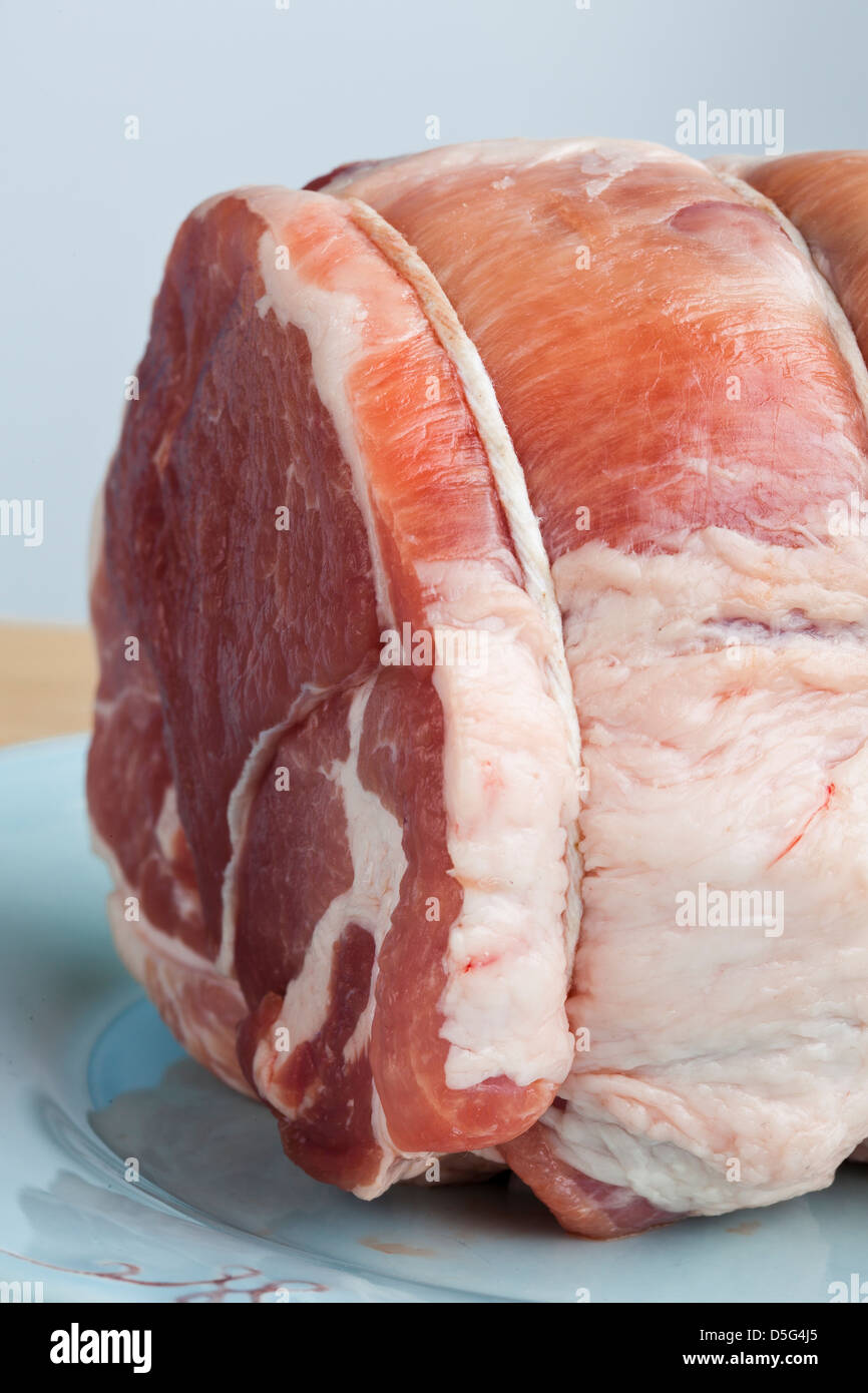 2.5 pound raw pork roast on a blue plate Stock Photo