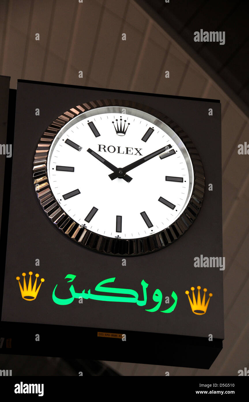 Rolex clock in departures hall of Dubai international airport UAE Stock Photo
