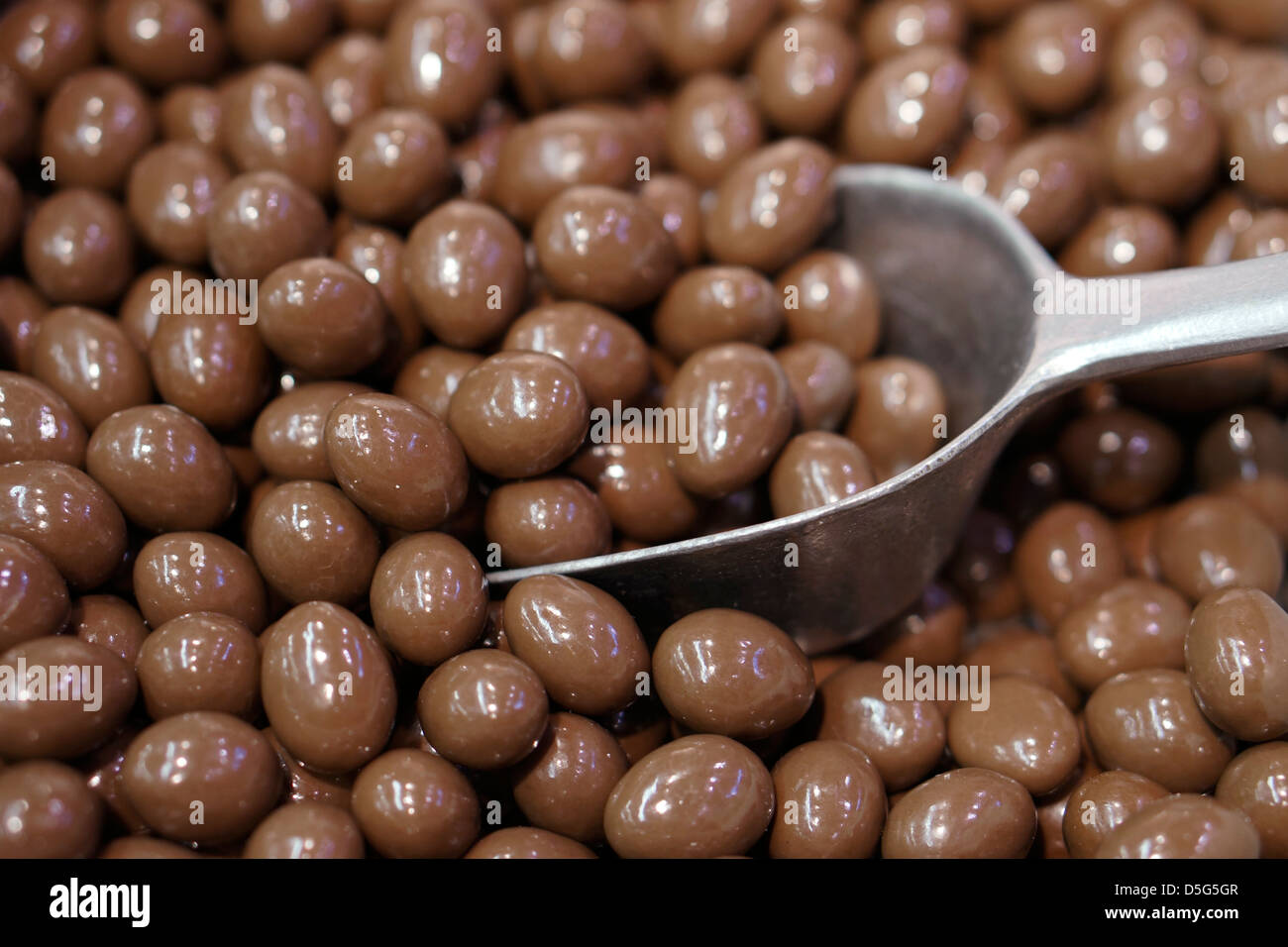 Chocolate covered almonds in French coin dispenser candy machines Stock  Photo - Alamy