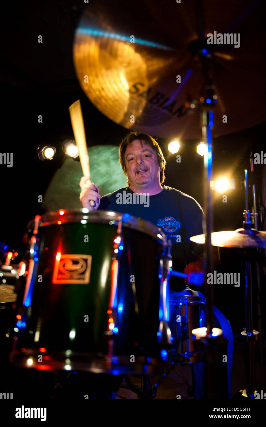 Man playing drums on stage Stock Photo