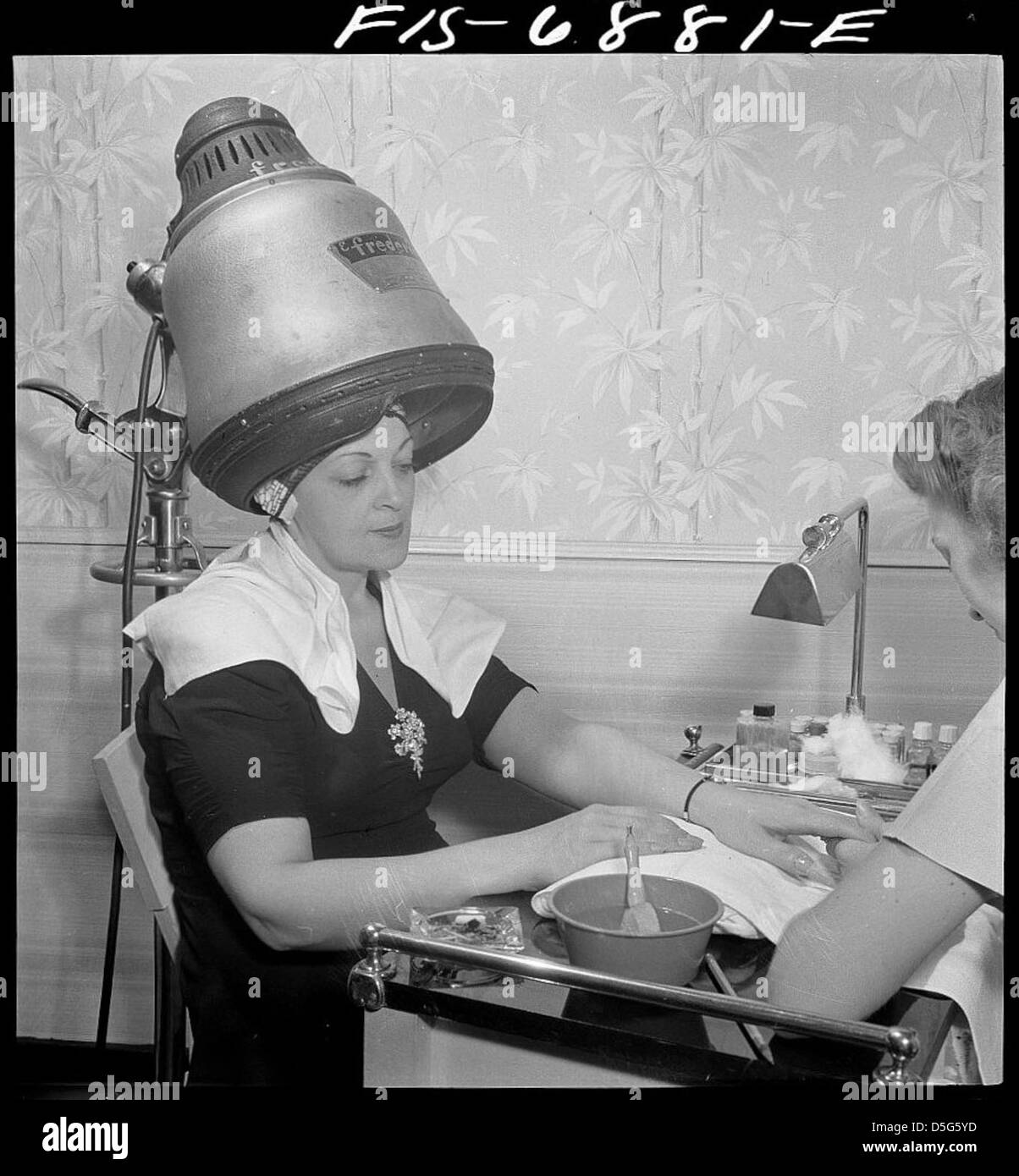 New York, New York. Getting a manicure while drying hair at Francois de Paris, a hairdresser on Eighth Street (LOC) Stock Photo