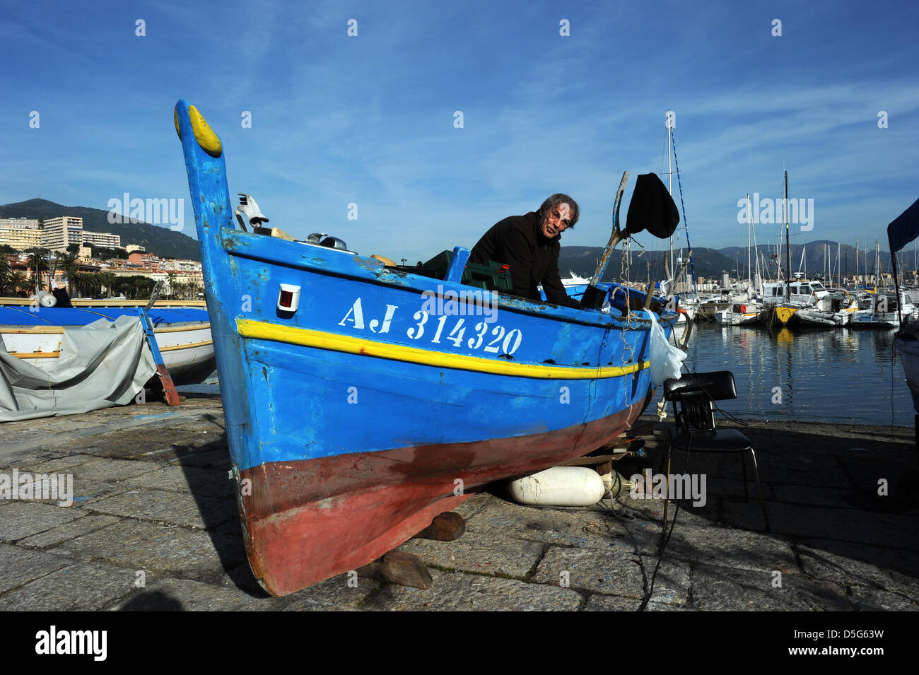 Fisherman traditional boat Ajaccio Corsica man Corsican Stock Photo