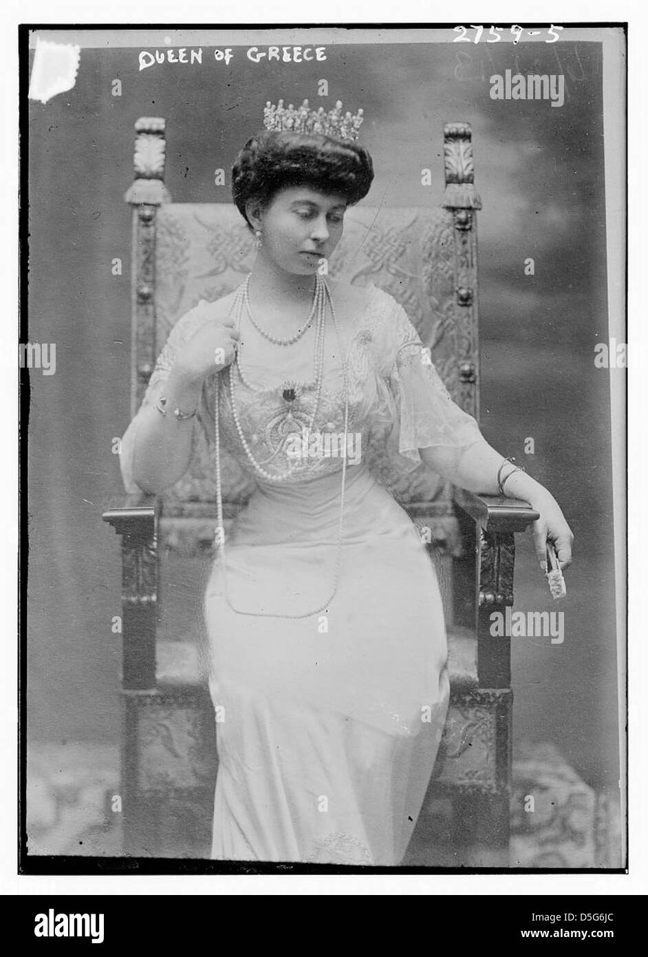 This black-and-white portrait of Queen Sophia of Greece shows her seated on a throne, wearing a crown and pearls, symbolizing her royal status in the early 20th century. Stock Photo