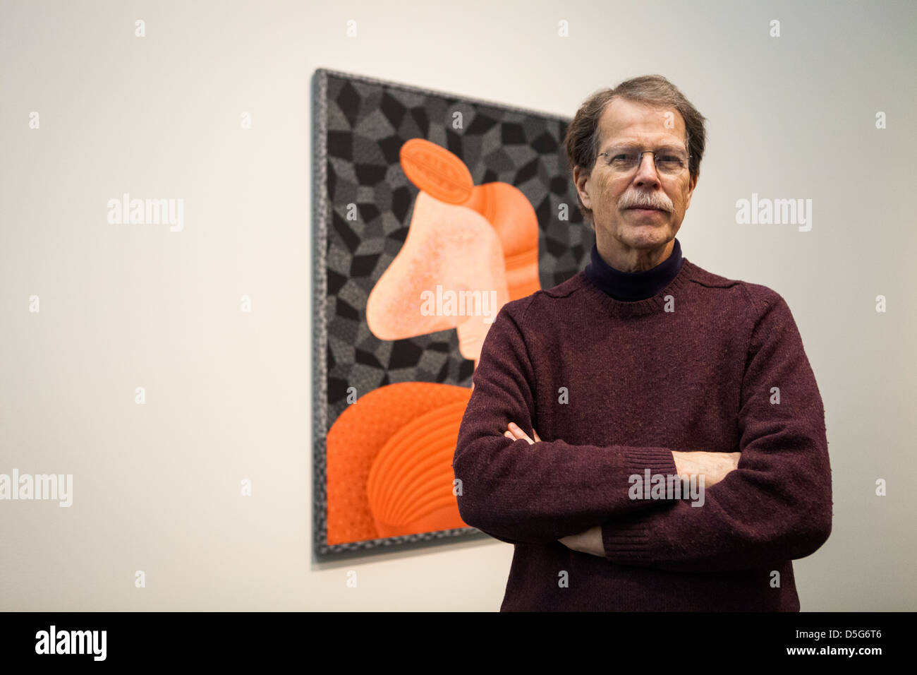 Artist Jim Nutt at the Museum of Contemporary Art in Chicago, with one of his paintings in the background. Stock Photo