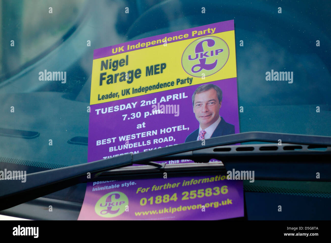 Notice of local UKIP meeting with Nigel Farage MP under a car windscreen wiper Tiverton Devon Stock Photo