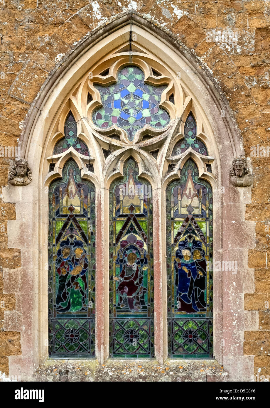 Old stained glass window and Gothic masonry, St James Church, Little Dalby, Melton Mowbray, Leicestershire, England, UK Stock Photo