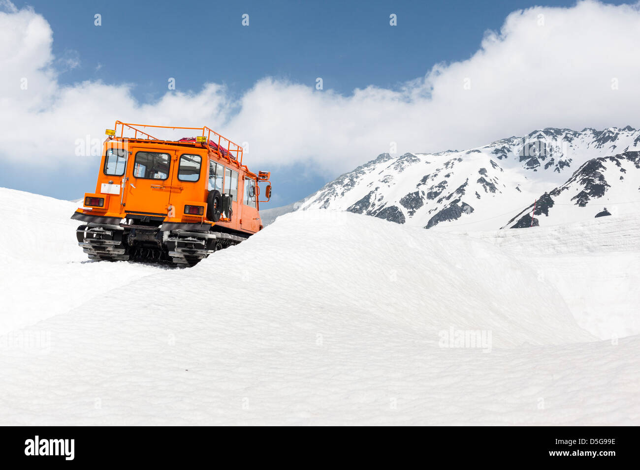 Back view of a mountain rescue vehicle with caterpillar tracks on a snow-capped mountain Stock Photo