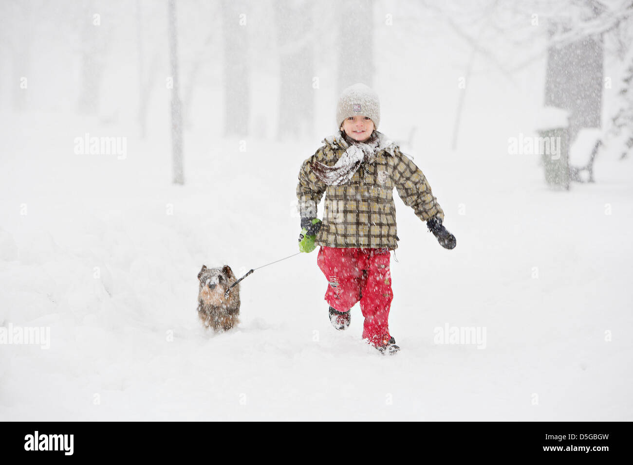 Czeski Cieszyn (Cesky Tesin), Czech Republic. March 31, 2013.  Boy with a dog is seen during hefty snow flurry at Easter time. Credit: CTK Photo/Martin Sterba/Alamy Live News Stock Photo