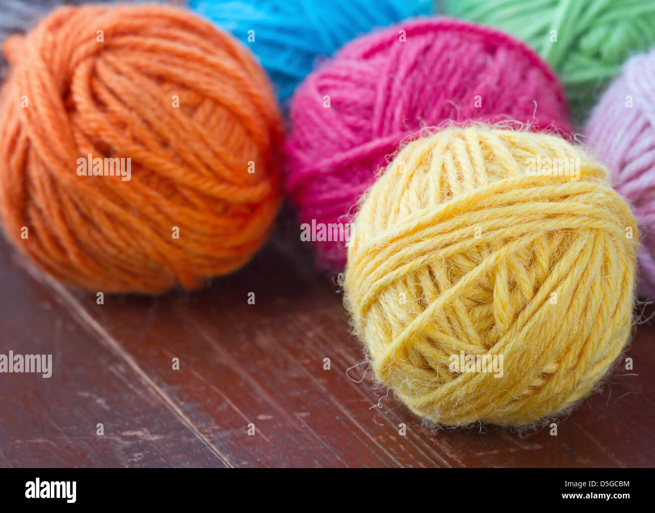 Closeup of colorful woolen yarn on old vintage wooden background Stock Photo
