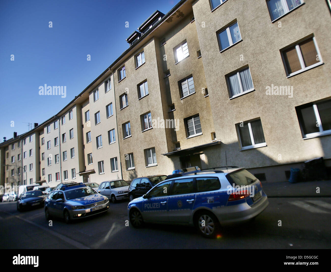 Police cars are parked in front of a house in which a fire broke out on Easter Saturday in Cologne, Germany, 02 April 2013. Two people died in the fire and 13 more were injured in the house with many tenants of Turkish origin. The fatal victims had no Turkish origin. Photo: OLIVER BERG Stock Photo