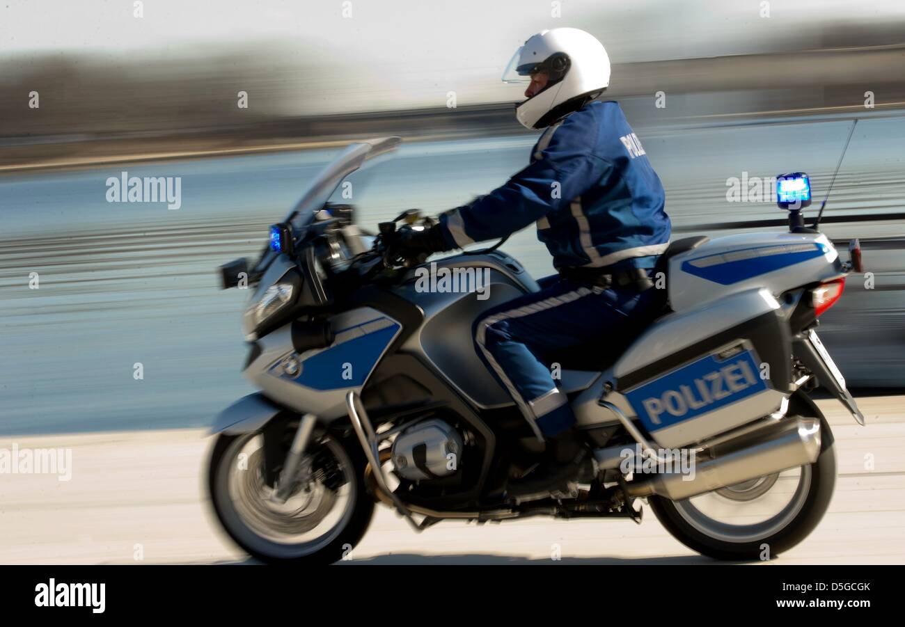 A police officer cruises on his new motorcycle at the Binnenalster in