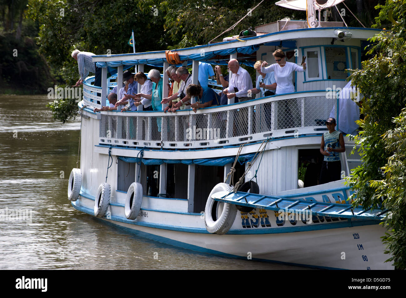 Tourists fishing piranha on Amazon river near Santarem, Brazil Stock Photo