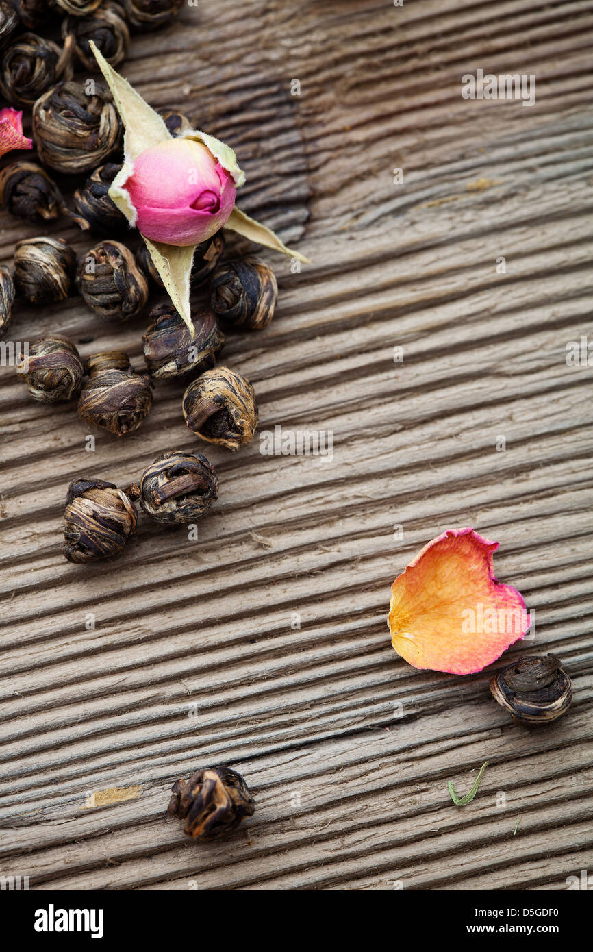 Fresh green tea leaves with rose buds Stock Photo