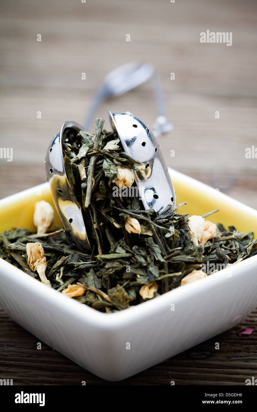 Fresh green tea leaves with jasmine flowers Stock Photo