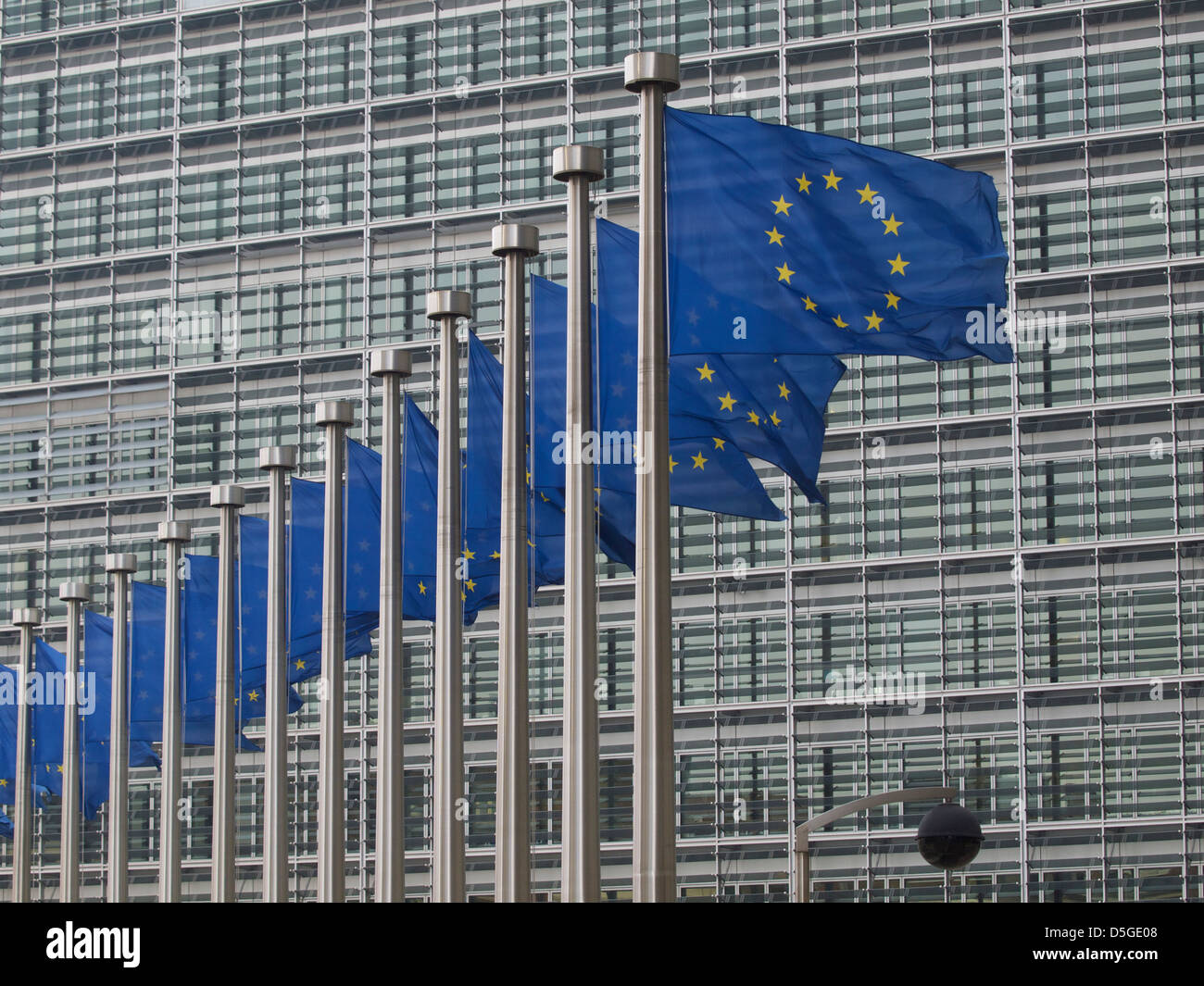 European Union flags in front of the Berlaymont building of the European Commission in Brussels, Belgium Stock Photo