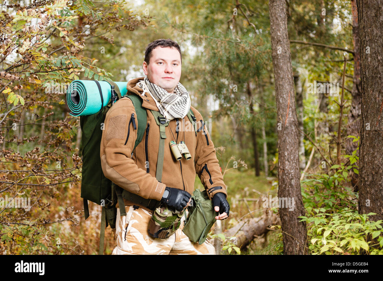 Soldier with rucksack in a forest. Stock Photo