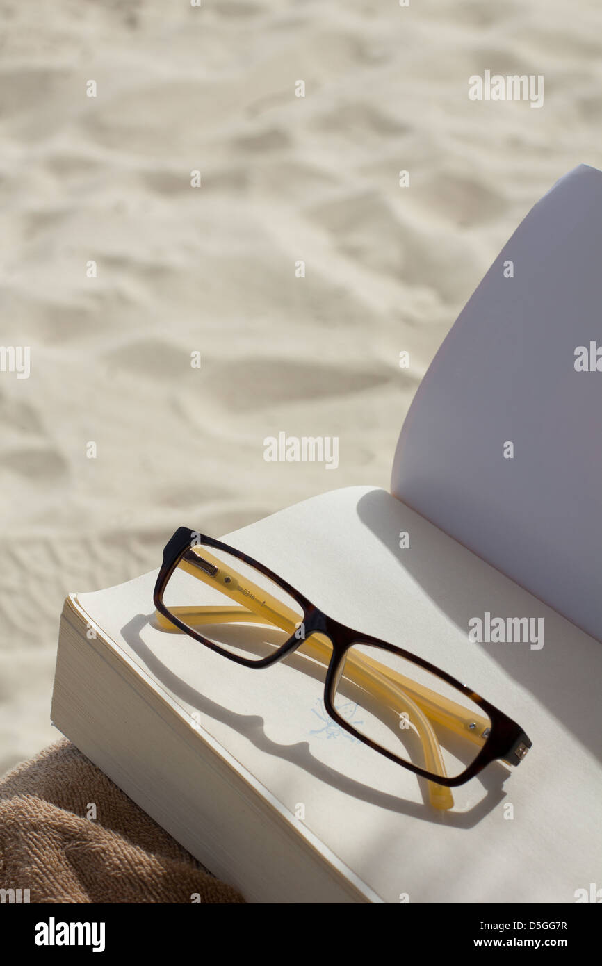 glasses book and ocean Stock Photo Alamy