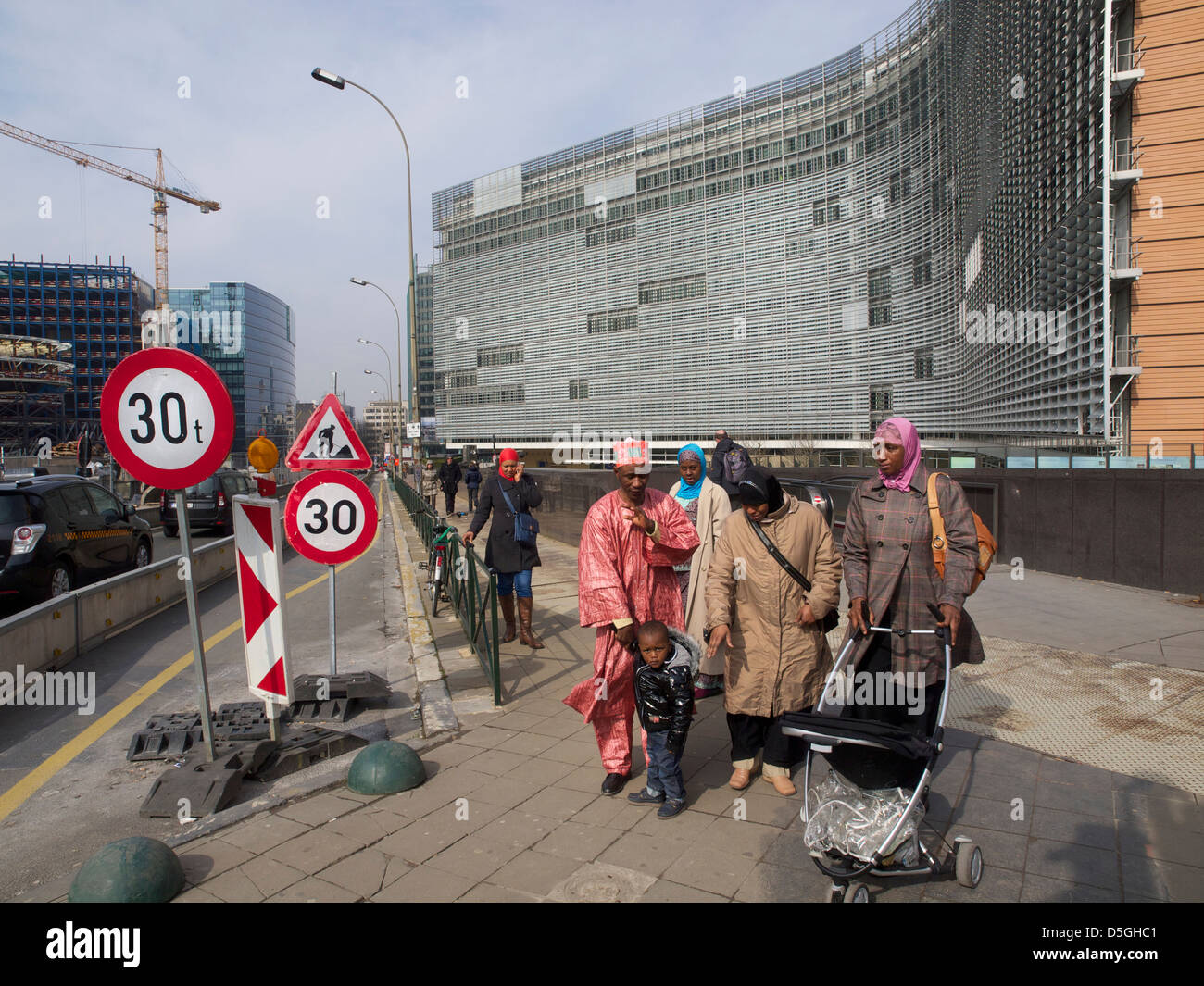Traditionally dressed muslim African family looking out of place at the Berlaymont EU building in Brussels, Belgium Stock Photo