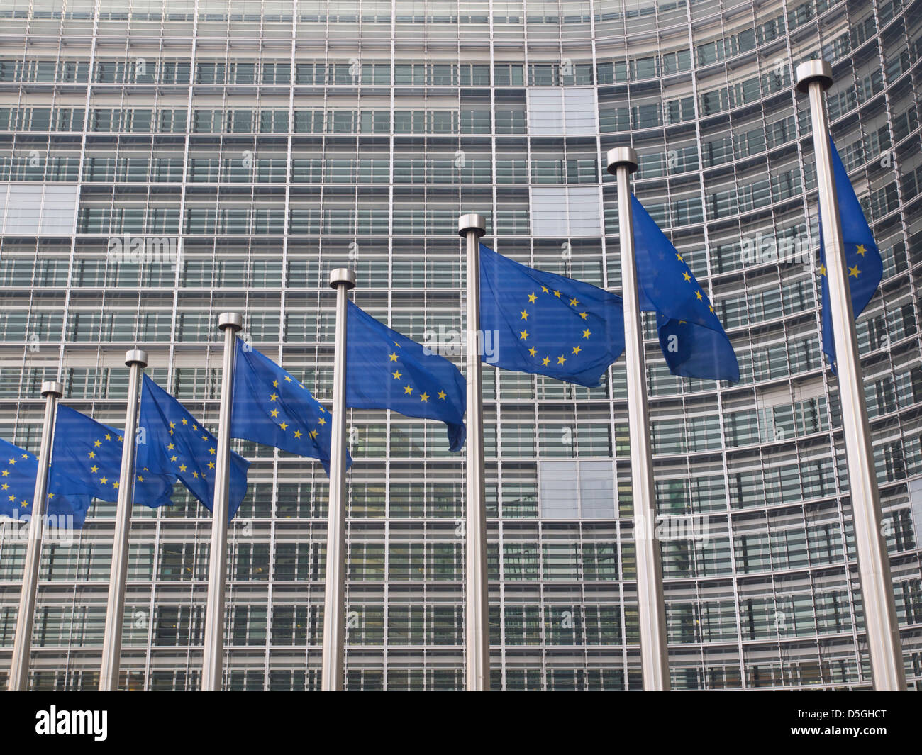 European Union flags in front of the Berlaymont building of the European Commission in Brussels, Belgium Stock Photo