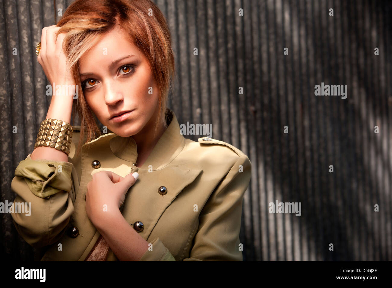 Woman red hair metal building with shadows Stock Photo