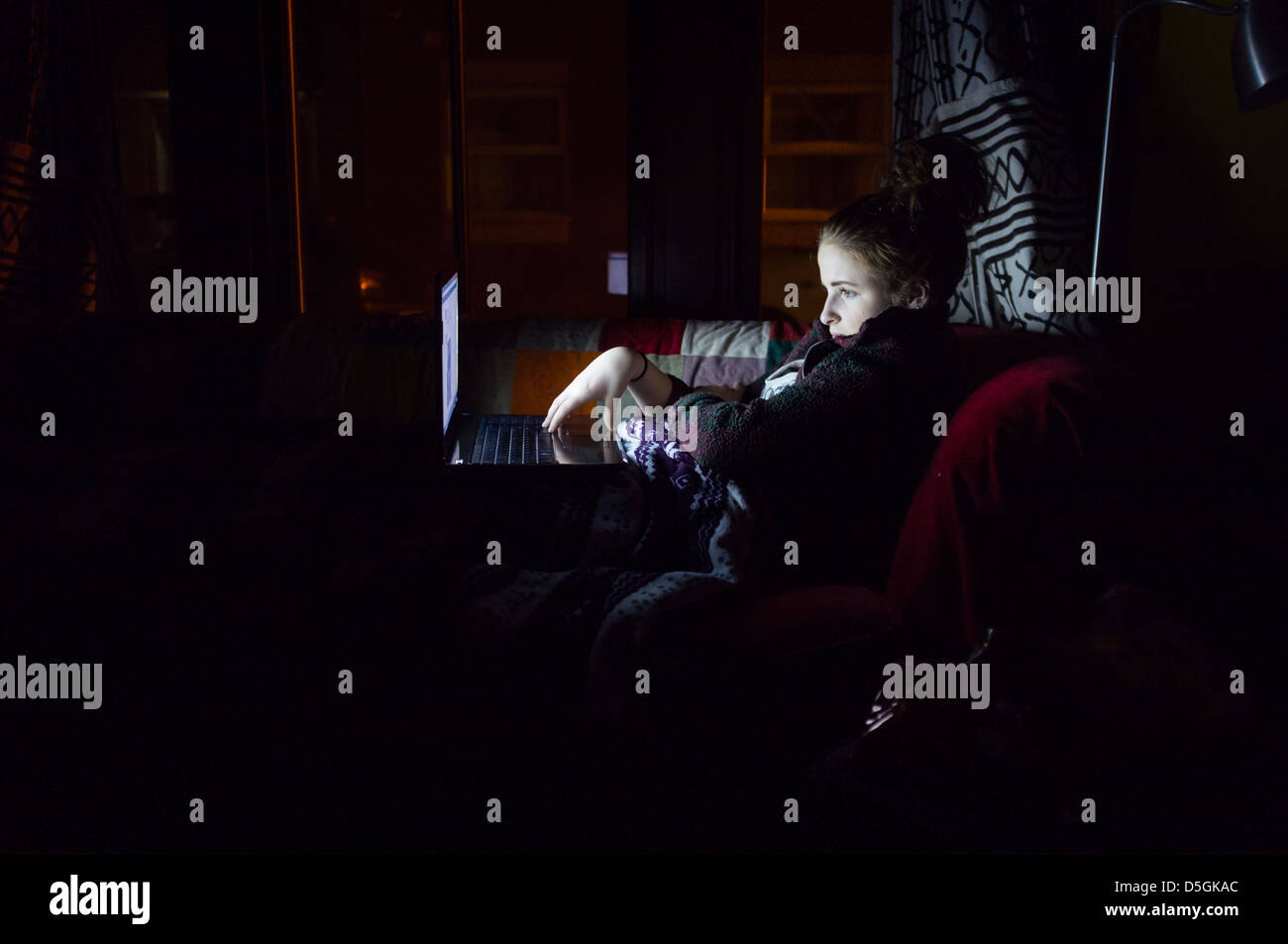 A fourteen year old teenage girl child using her laptop computer to