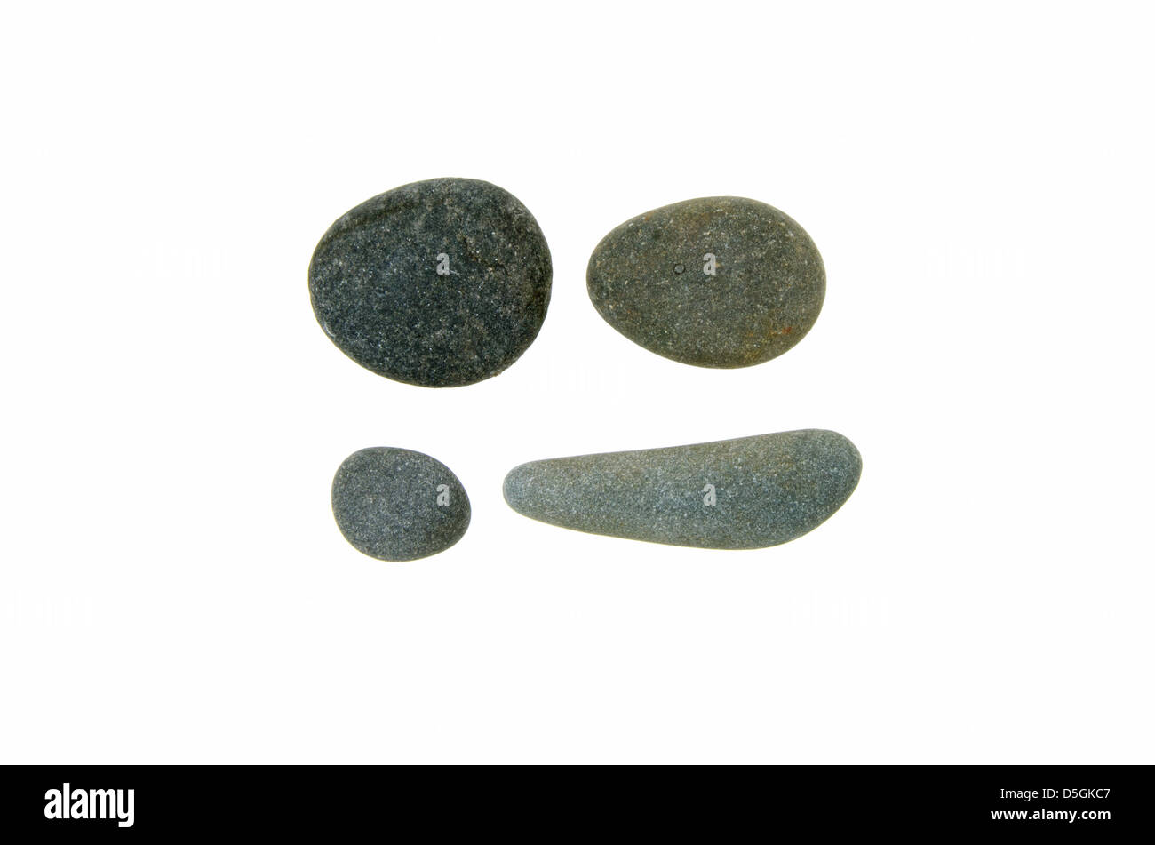 Four smooth, round beach stones of Maine granite and schist. Stock Photo