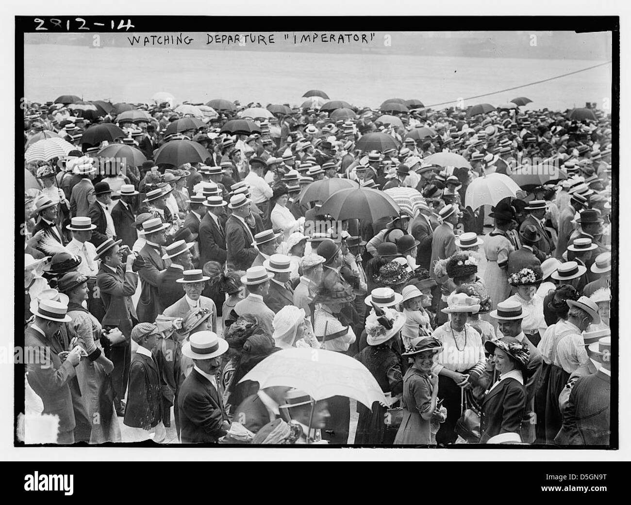 The photograph captures the departure of the ocean liner RMS Imperator from port. Built by AG Vulcan, the Imperator-class liner was part of the Hamburg-Amerikanische Packetfahrt-Actien-Gesellschaft and later served as the USS Imperator. Stock Photo