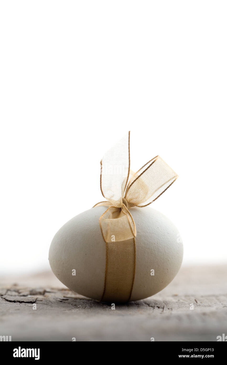 White easter eggs with beautiful golden bow Stock Photo - Alamy