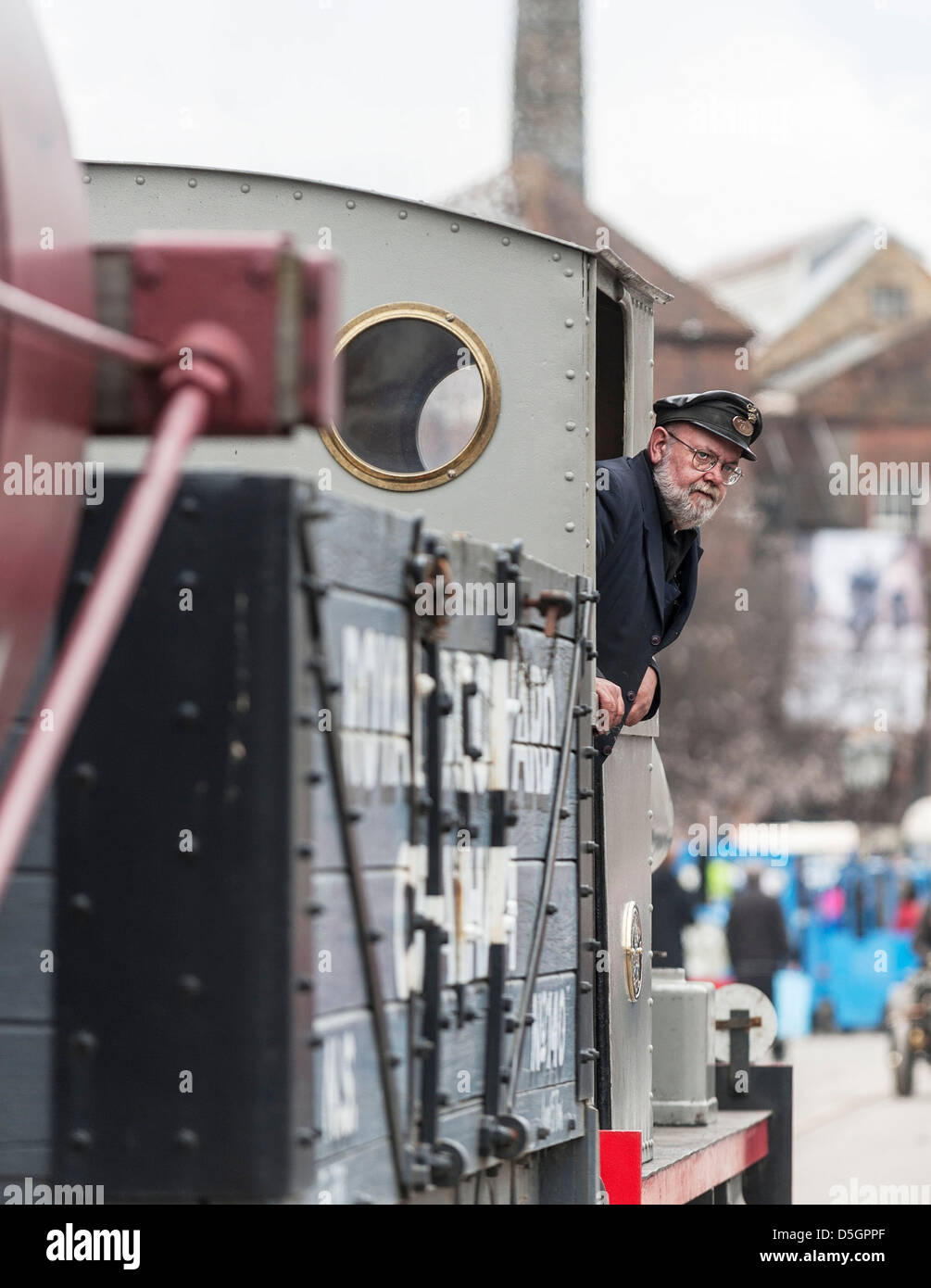 A train driver looking out of the locomotive. Stock Photo