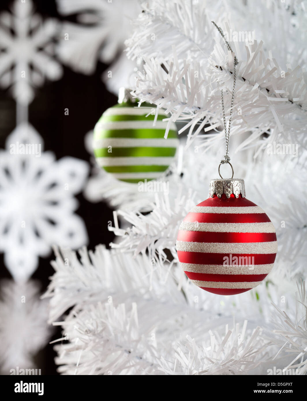 Colourful christmas baubles hanging from white christmas tree Stock ...
