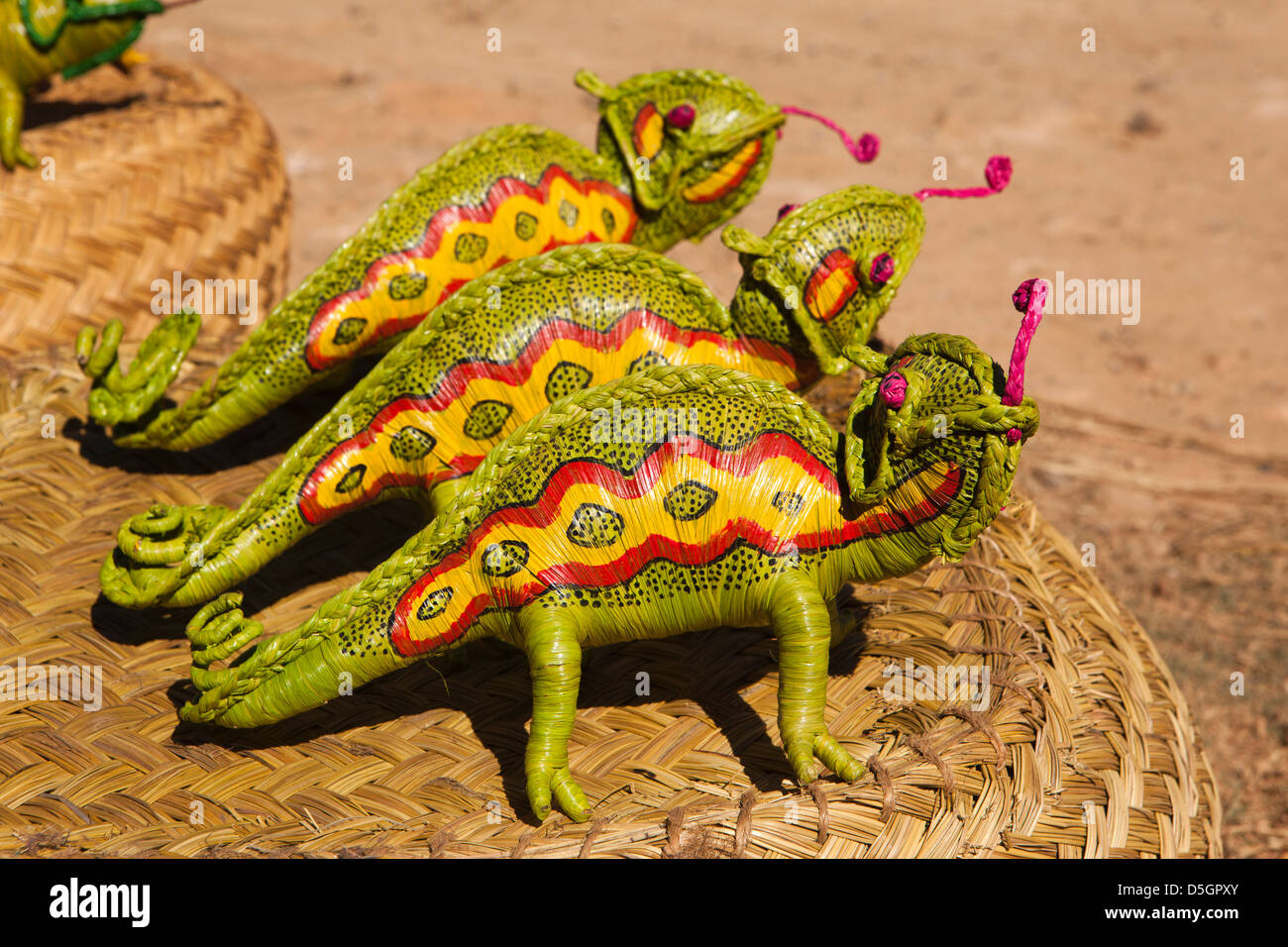 Madagascar, Ambatolampy, roadside stall selling raffia animals, chameleons Stock Photo