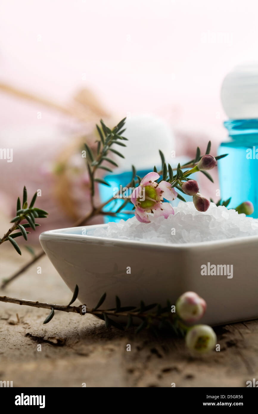 White bath salt with branch of pink flower Stock Photo