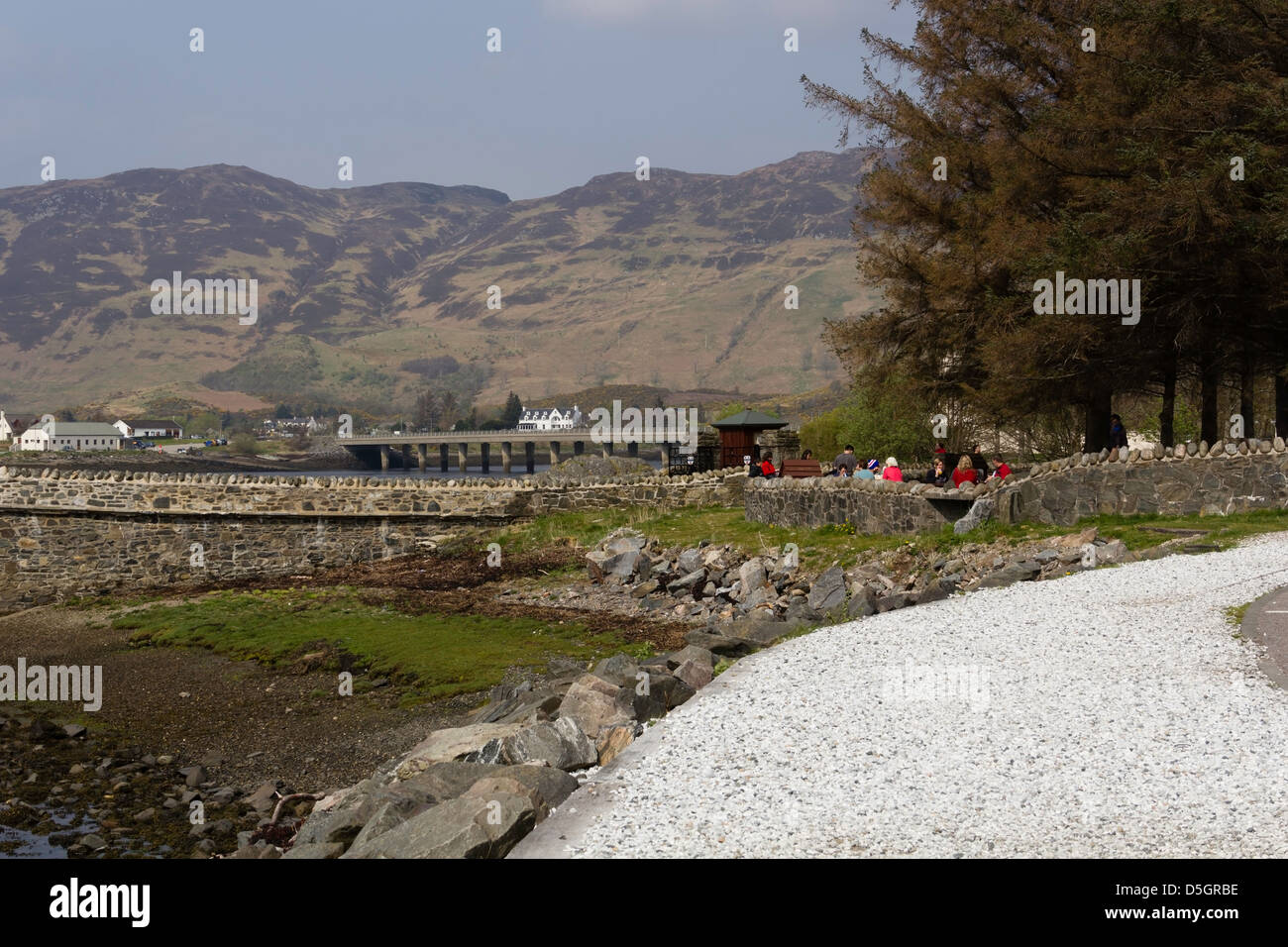 Landscape outside the entrance to the Eilean Doonan Castle in Scotland. The ticketing gate and the bridge to castle is visible. Stock Photo