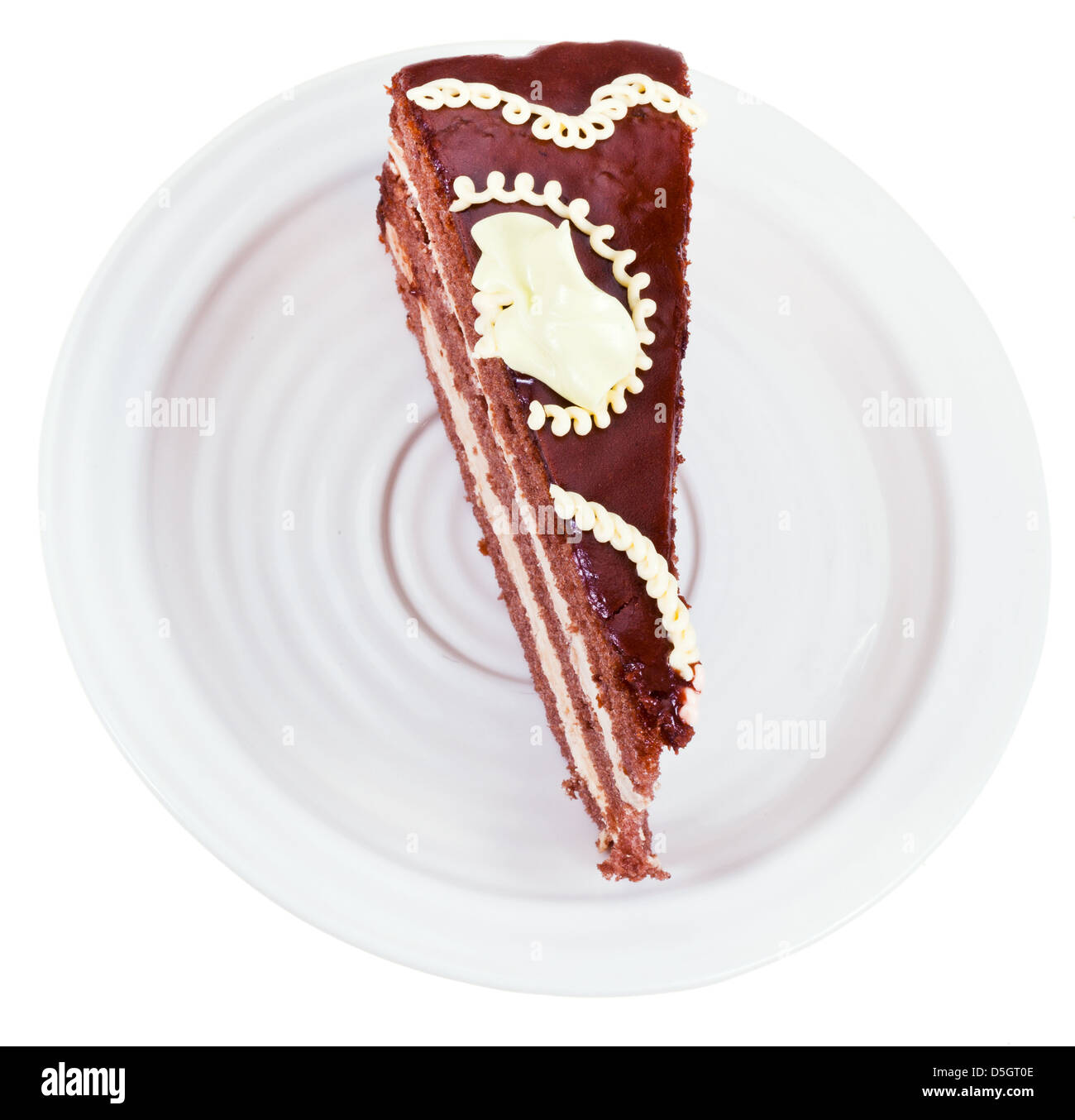 top view of chocolate cake piece on plate isolated on white background Stock Photo