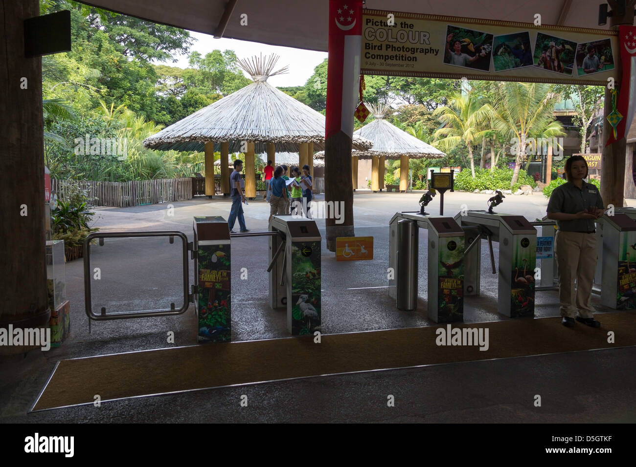 Turnstile at the entry to the Jurong Bird Park along with an attendant. These gates are located just after the ticketing point Stock Photo