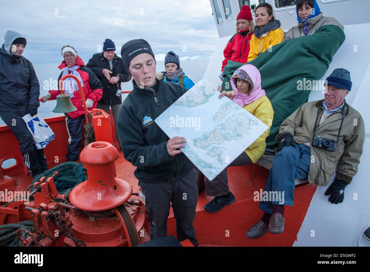 Tour guide on boat talking to tourists about Icefjord, Ilulissat (Jakobshavn), Greenland Stock Photo