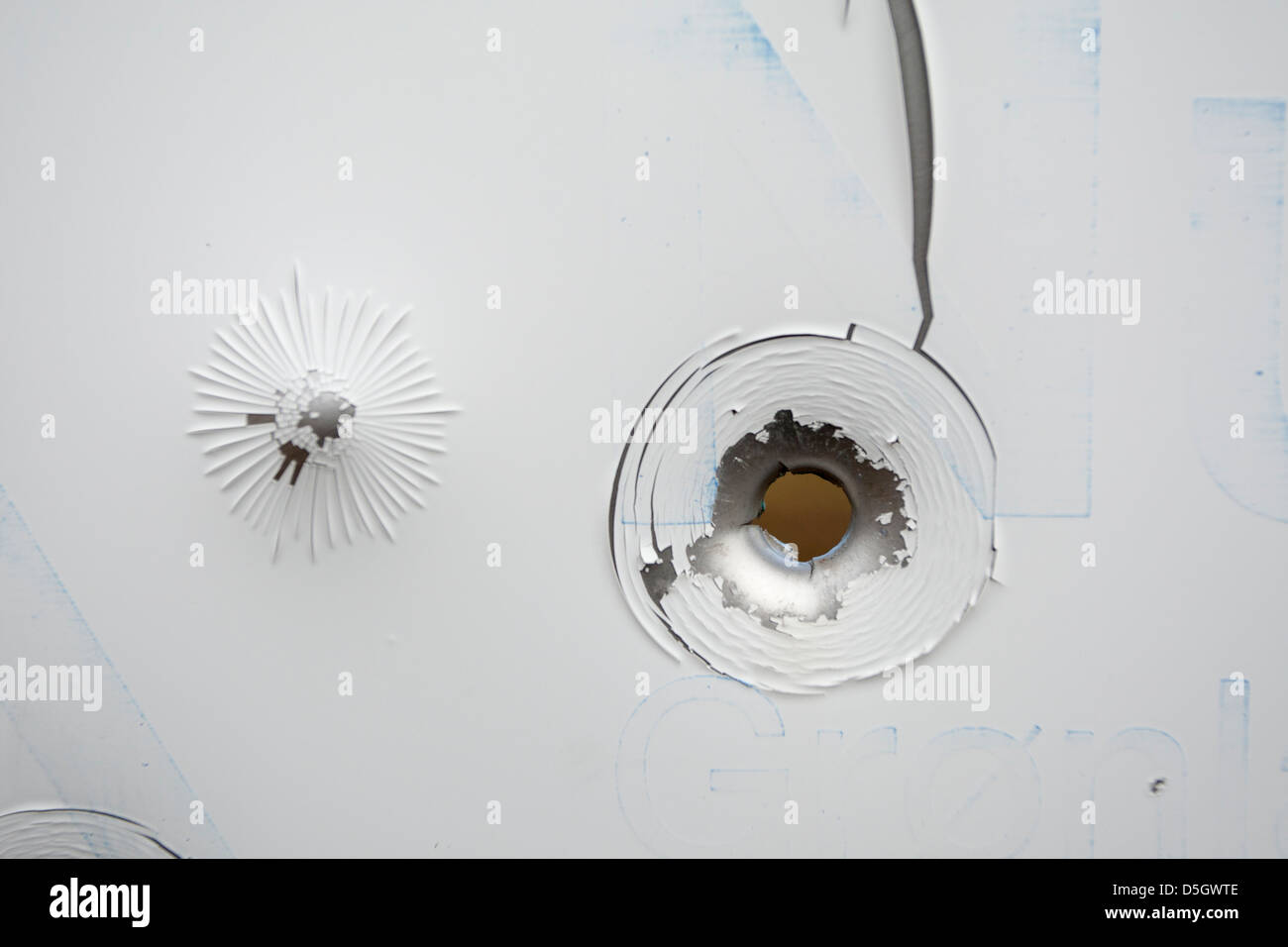 Bullet hole in metal sign Stock Photo