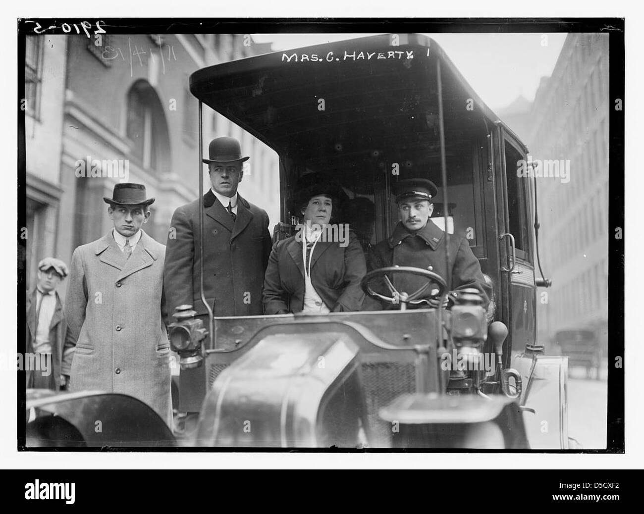 This image features Mrs. G. Haverty, an Atlanta native, posing as a taxi cab owner and driver in New York City. The photograph highlights her role as a female entrepreneur in the 20th century. Stock Photo