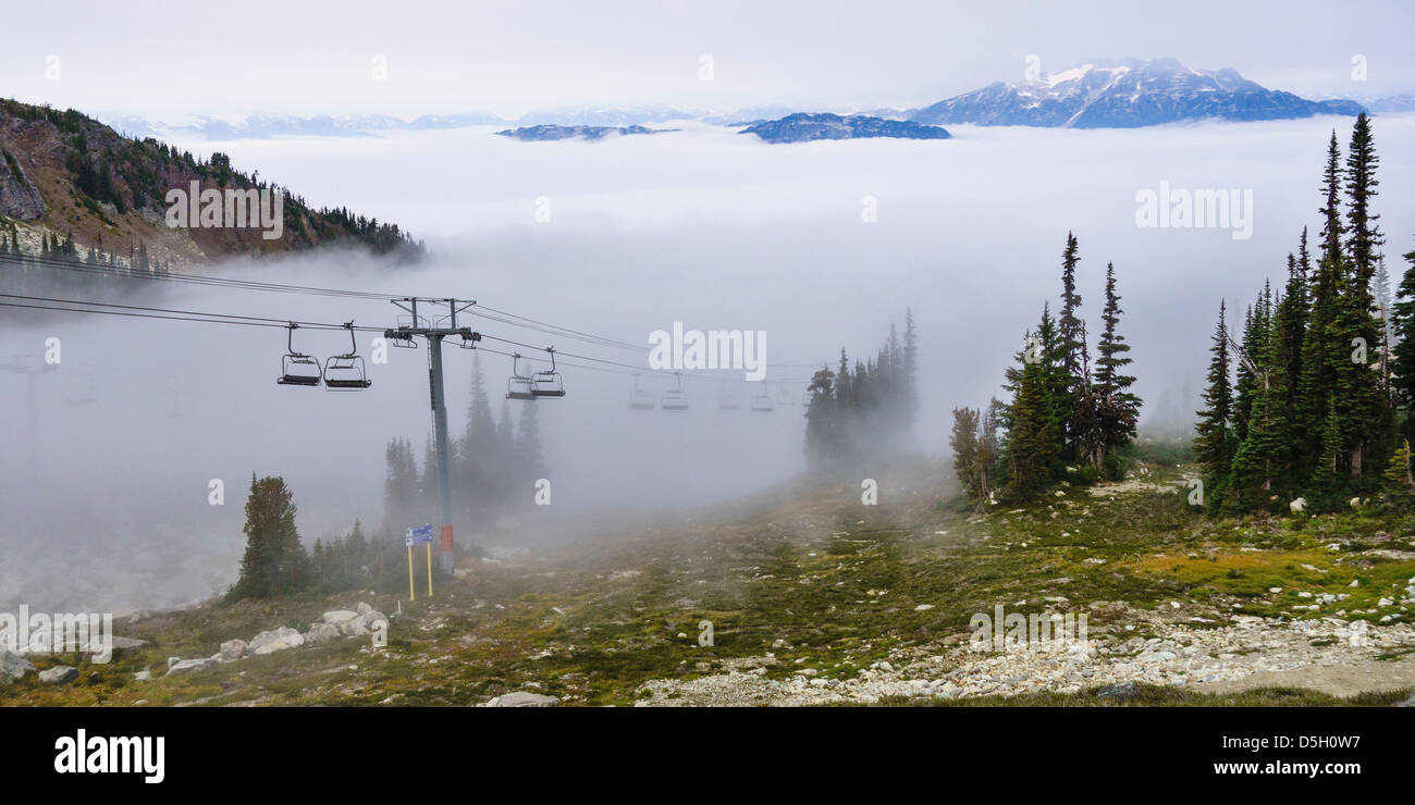 British Columbia, Whistler. Chairlift coming out above the clouds on Whistler Mountain. Stock Photo