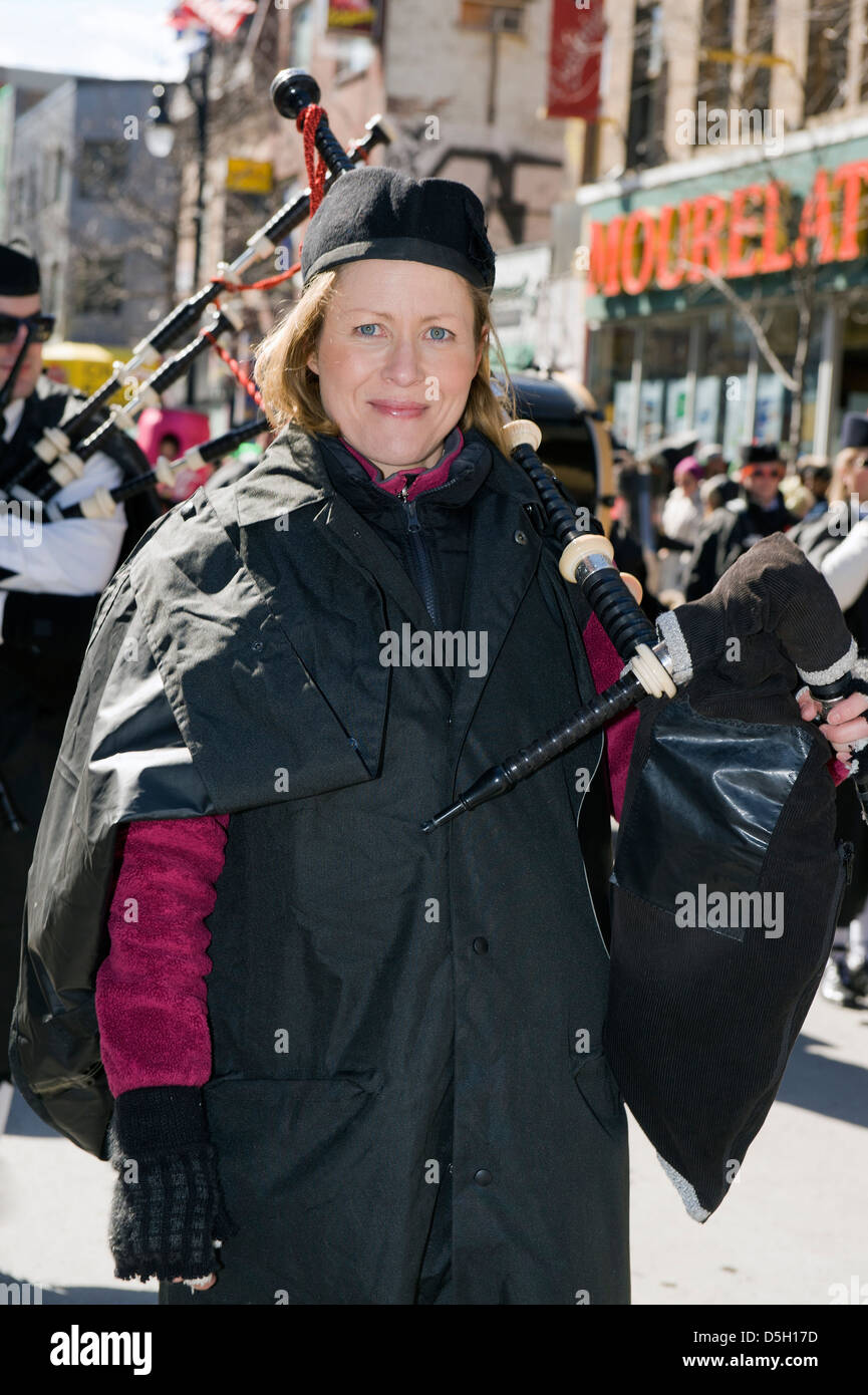Female bagpipe player at the St Patrick's day parade in Montreal, province of Quebec, Canada. Stock Photo