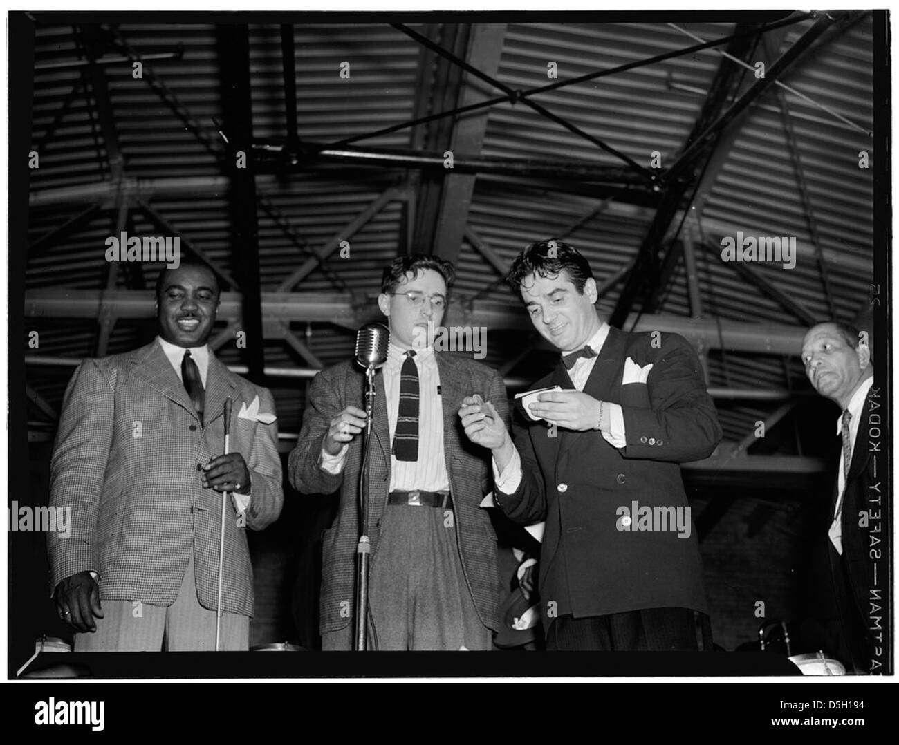 A 1940s portrait featuring jazz musicians Jimmie Lunceford, William P. Gottlieb, and Gene Krupa in Washington, D.C. They are pictured in checked suits, capturing a moment in jazz history. Stock Photo