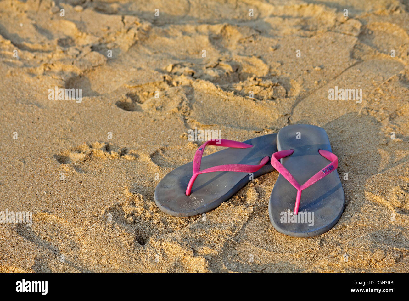 Flip-flops on the beach Stock Photo - Alamy