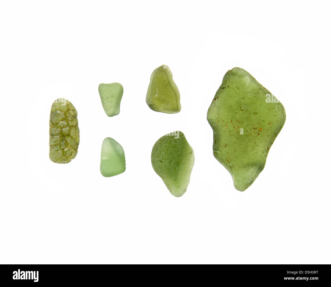 Six pieces of weathered green sea glass found on the coast of Maine. Stock Photo
